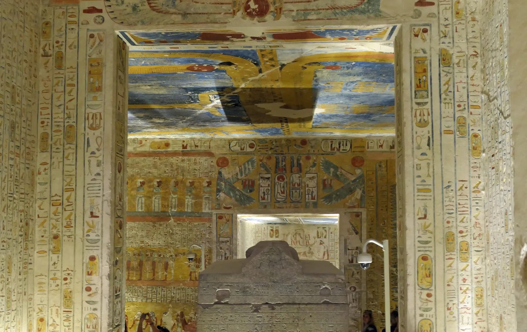 Tomb of Ramesses IV (KV2), view through painted doorways into the burial chamber with the granite sarcophagus and vulture ceiling