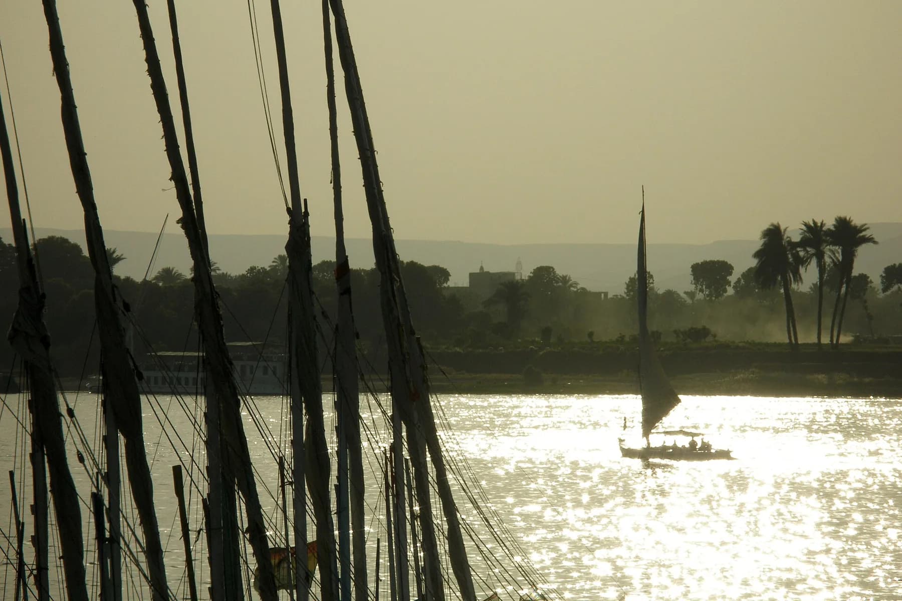 Backlit feluccas on the Nile at Luxor, late afternoon