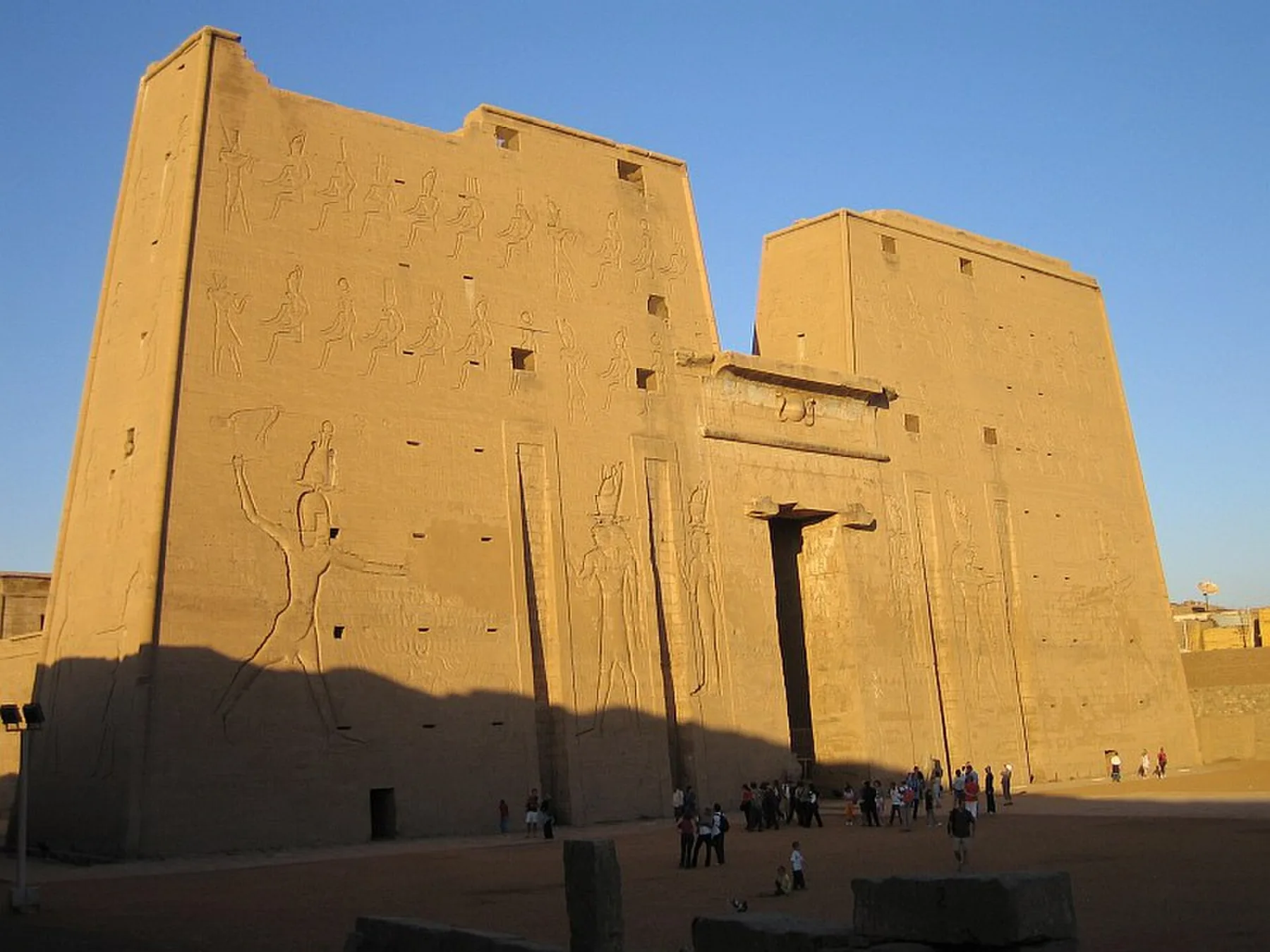 Edfu temple pylon with visitors at distance