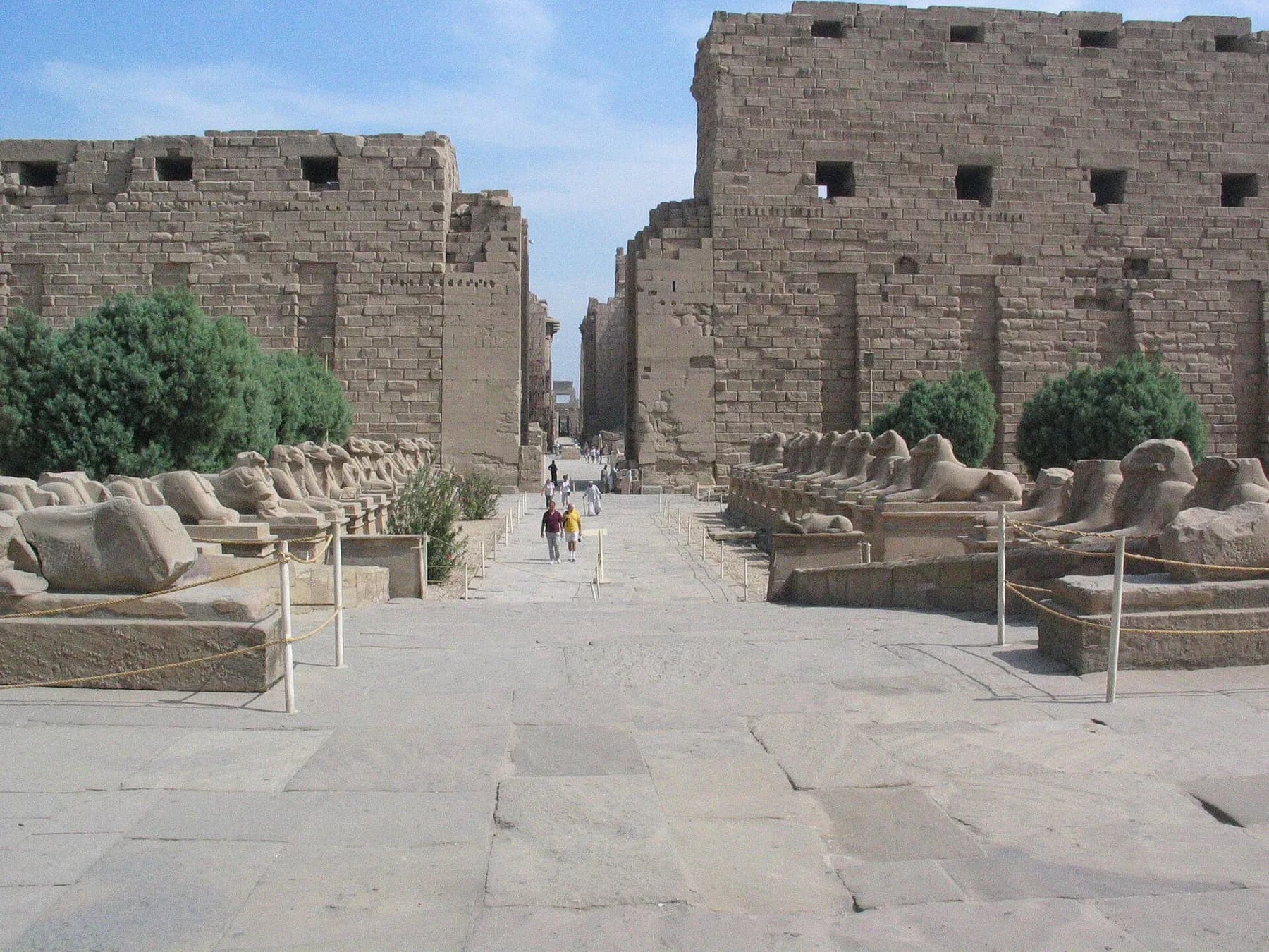 Karnak first pylon and ram-headed sphinxes, visitors at distance