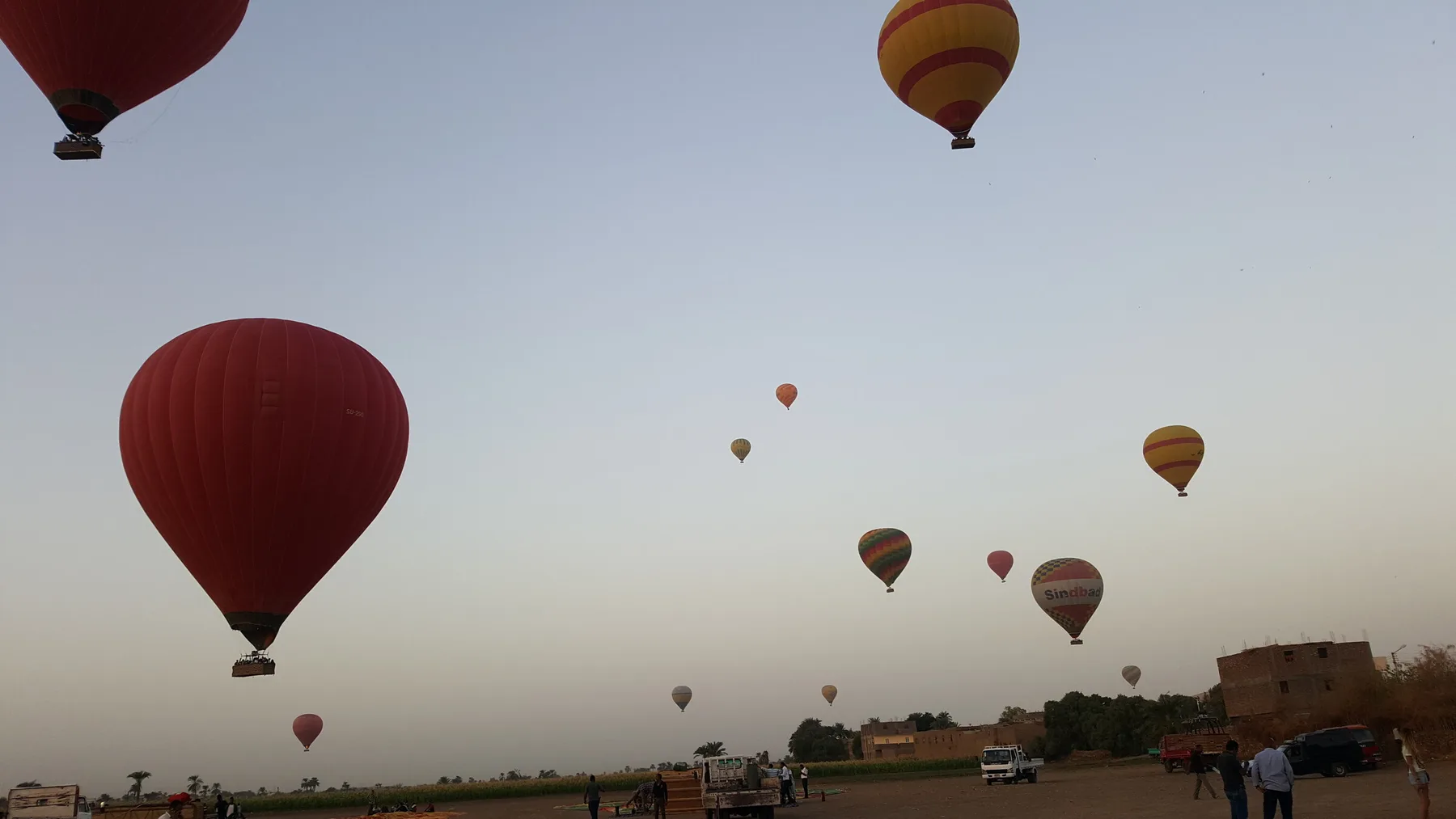 Dozens of hot-air balloons rising over the West Bank at dawn