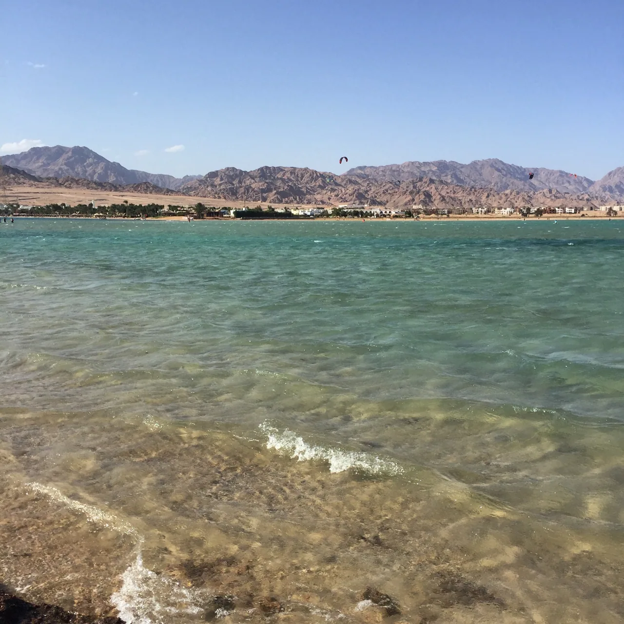 The shallow bay at Dahab with kitesurfers and the Sinai mountains behind