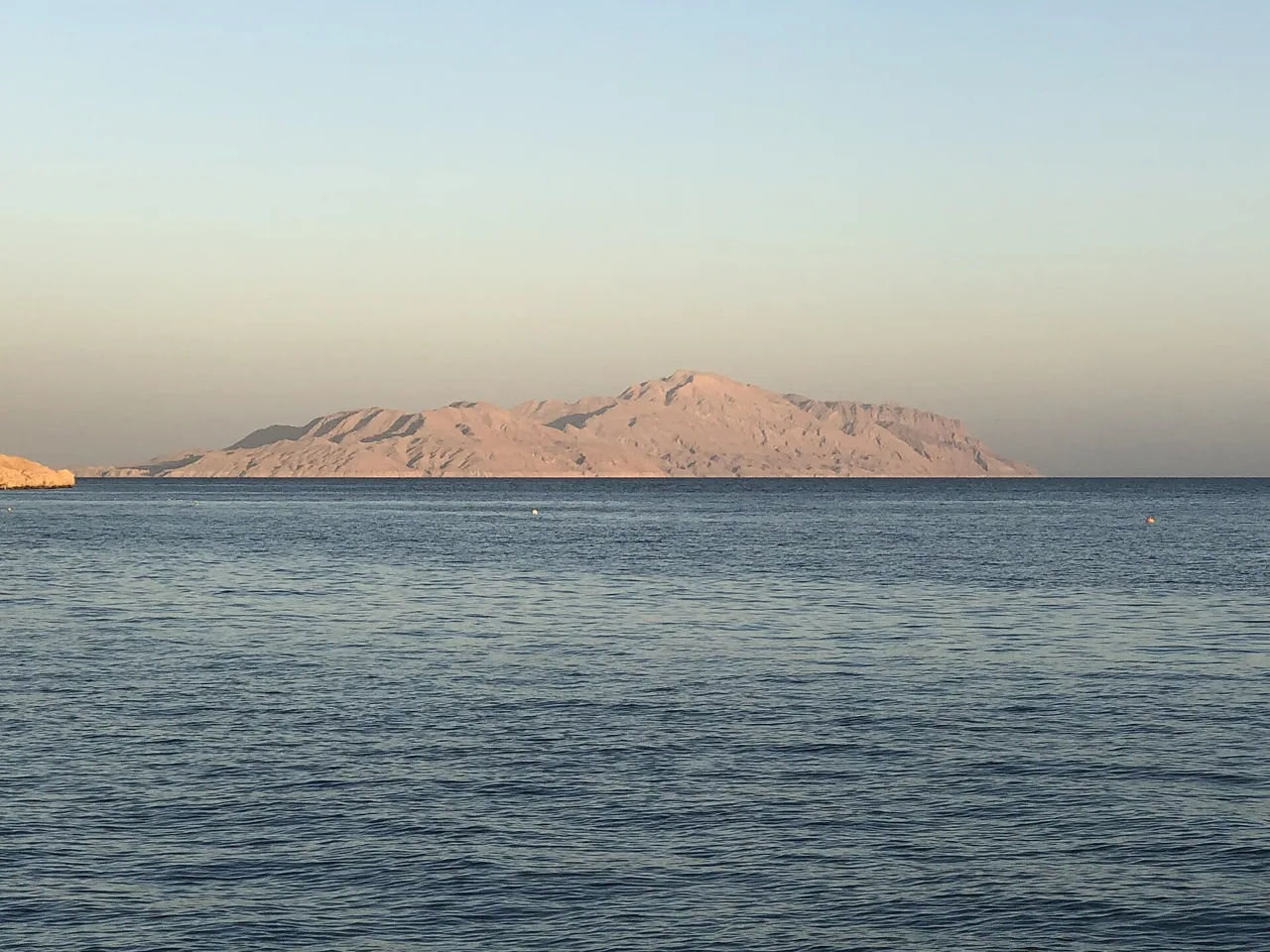 Tiran Island seen across the strait at dusk